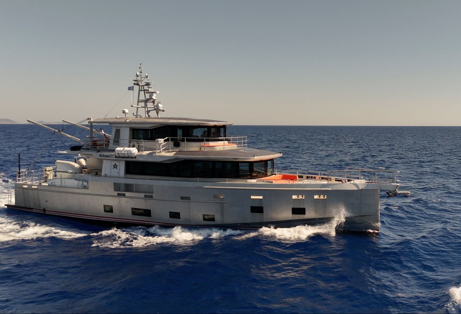 Arksen 85 sailing on the open ocean with a clear sky