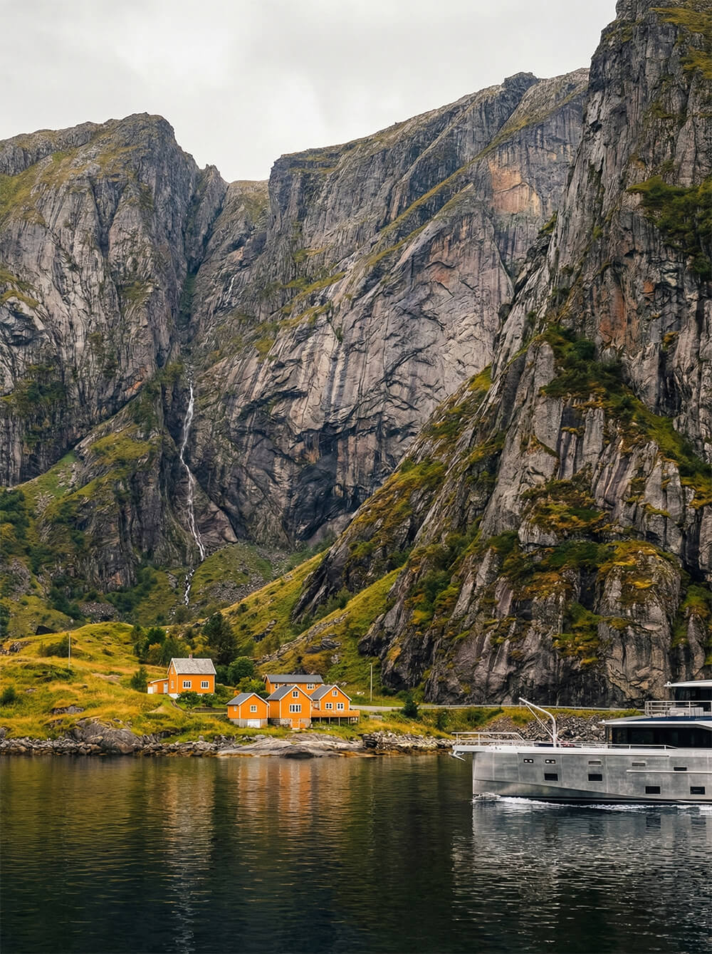 Arksen fractional yacht ownership showing the bow of the Arksen 85 against a dramatic background with yellow houses on the shore. 